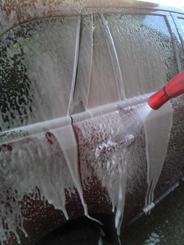 Car covered in foaming presoak at Denver self-service car wash