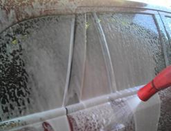 Foaming presoak being applied to vehicle