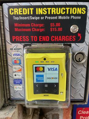 Credit card reader accepting contactless payment at car wash bay
